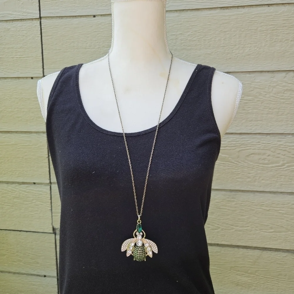 gold tone clear and green rhinestone bug pendant necklace